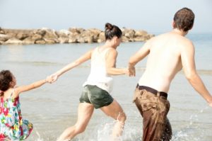 family playing on beach