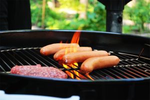 burgers and dogs on grill